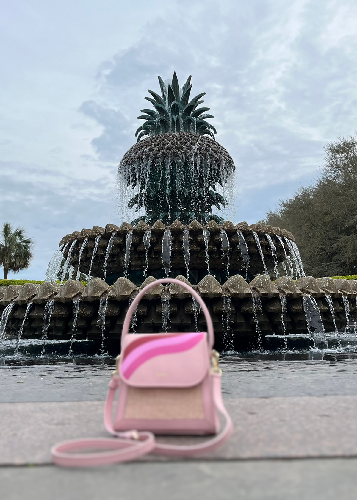 Qoffah handbag in front of Charleston's Rainbow Row