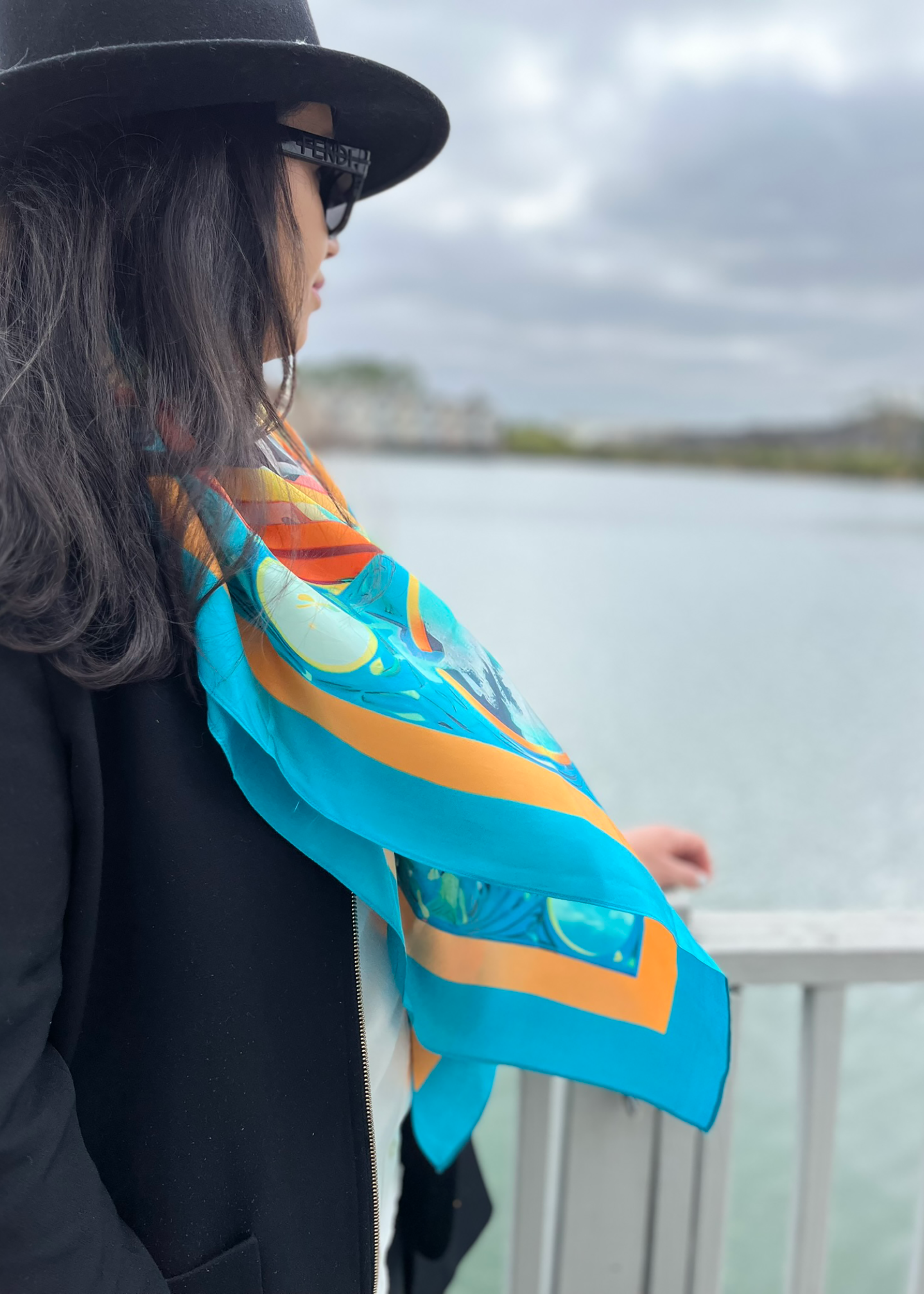 Founder of Qoffah surrounded by vibrant Moroccan fabrics